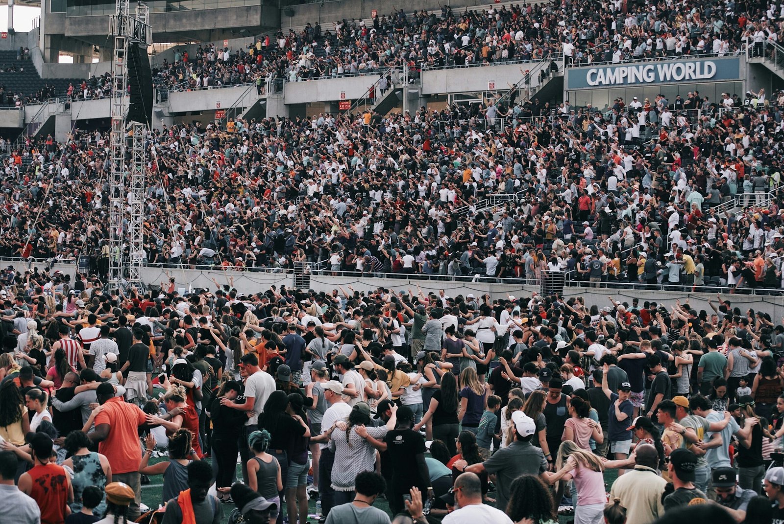 A packed crowd cheering during an Overwatch League event.